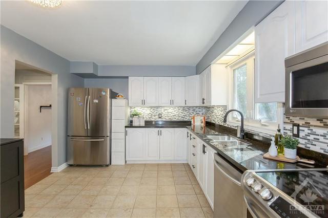 Kitchen with Granite Counter-top, Backsplash & SS Appliances | Image 12