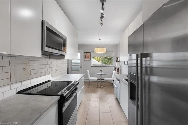 updated galley kitchen leading to your eat in kitchen area and balcony | Image 1