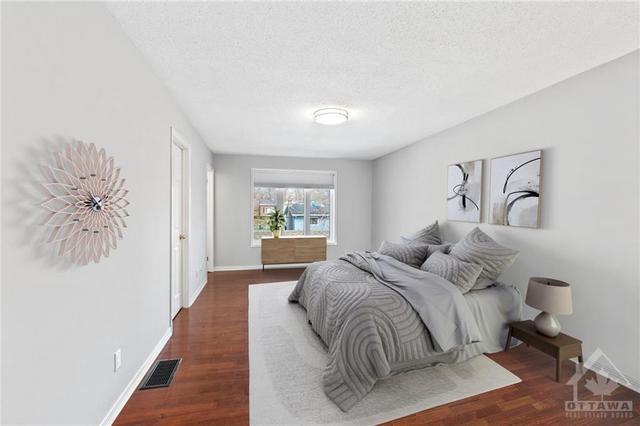 Expansive primary suite w/ large window, walk-in closet & en suite. (Virtually Staged). | Image 18
