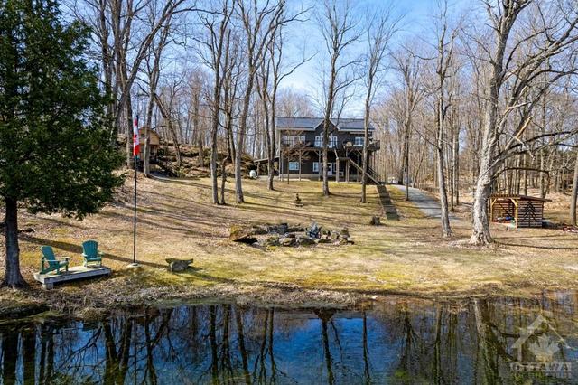 Located on treed acre along quiet Moore's Bay in Upper Rideau Lake | Image 1