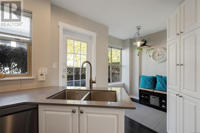 with quartz counters and undermount double sink and extra storage by the eating area | Image 13
