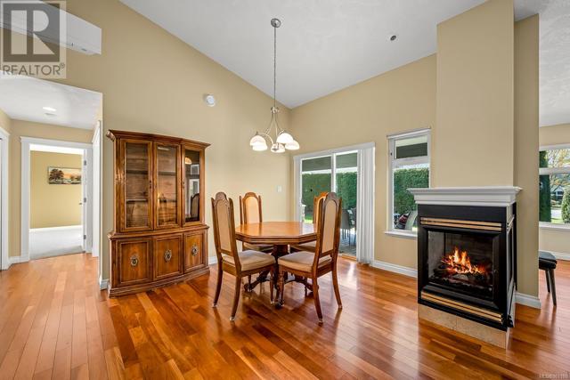 DINING ROOM WITH DOUBLE SIDED GAS FIREPLACE + SLIDING DOORS TO PATIO | Image 14