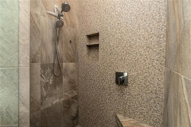 Glasses in steam shower with upgraded tile | Image 26