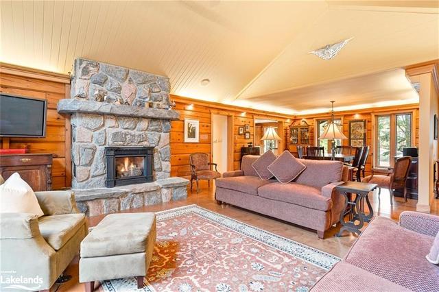 Comfortable, spacious living area with beautiful stone natural gas fireplace and walkout | Image 6
