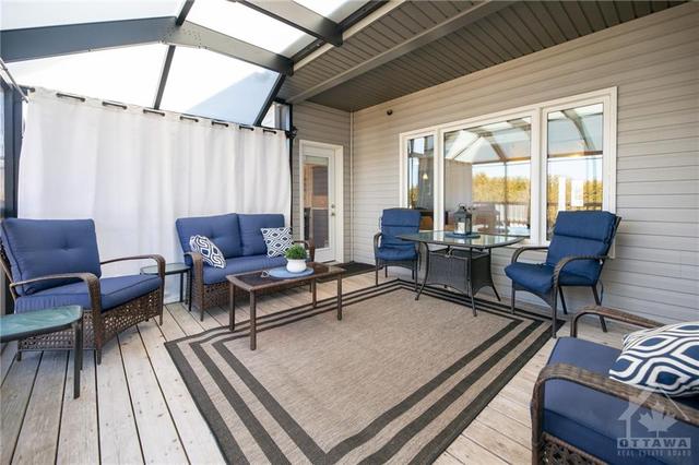 The professionally screened in sun-room offers access to the dining/kitchen as well as the primary! Plus privacy & protections from bugs | Image 29