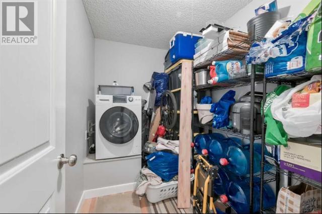 Combo washer/dryer unit located in the large storage room. There is also common laundry on the main floor | Image 21