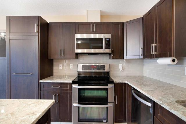 71 Cougar Ridge Mews Sw, Home with 2 bedrooms, 1 bathrooms and 2 parking in Calgary AB | Image 9
