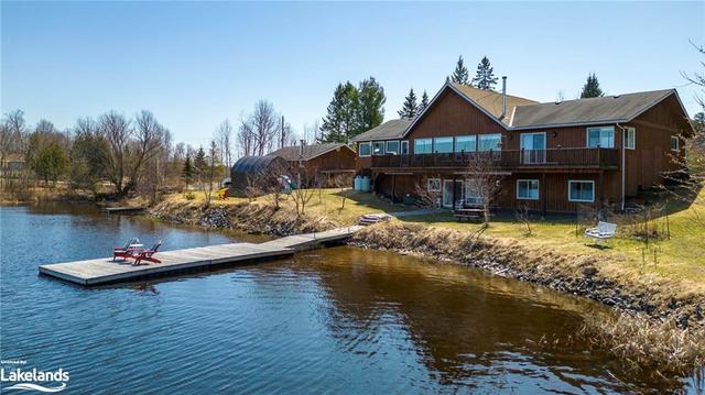 From the private dock, residents can relish in miles of boating opportunities along the 117 km shoreline, access the renowned 'Ridge at Manitou' Golf Course, and make use of the comprehensive marina s | Image 33
