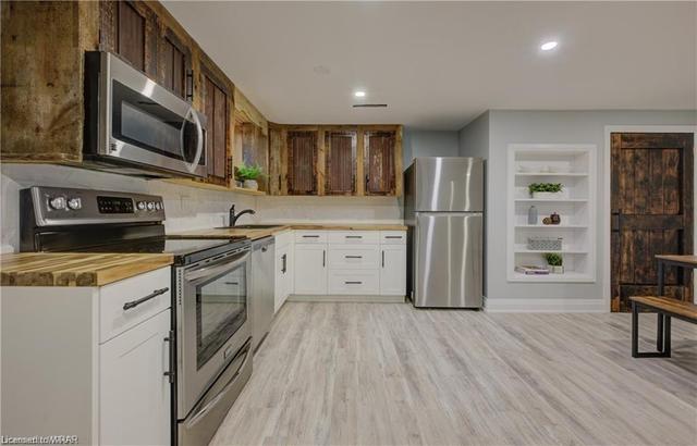 The walk-out basement with open-concept living/dining plus a full kitchen, features 2 bedrooms and would be an ideal in-law suite. | Image 17