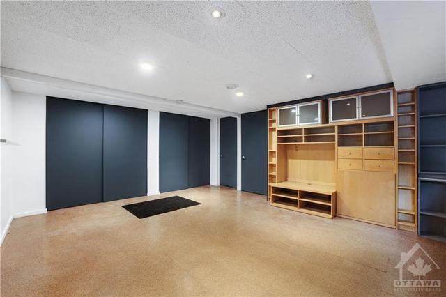 Lower level gym/games room . High ceilings, this room opens into  a large workshop which has exterior access. | Image 28