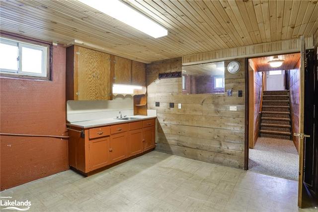 Basement bedroom with cabinetry and sink. | Image 9