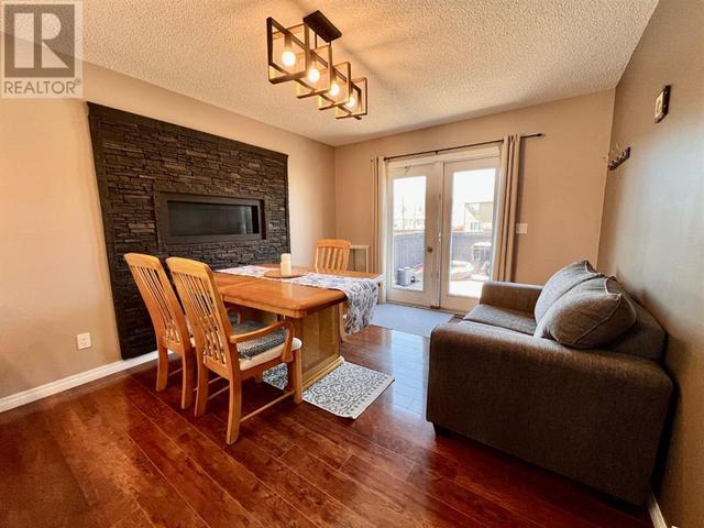 Dining area with gas fireplace and access to back deck | Image 5