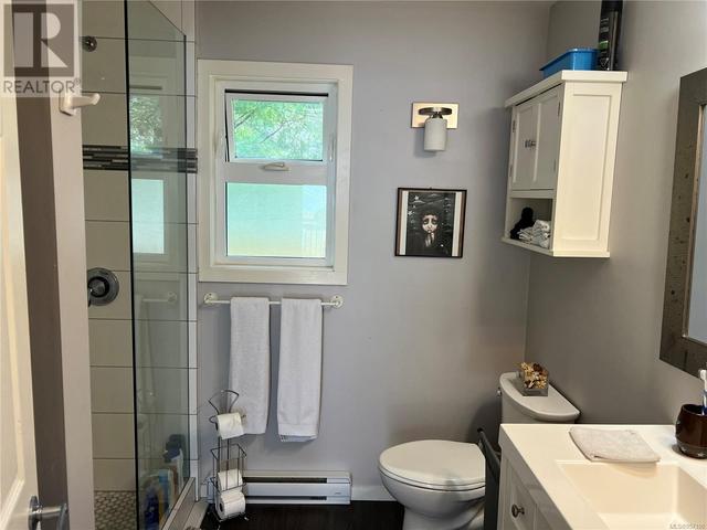 3pc bathroom with custom tiled shower & laundry closet | Image 12