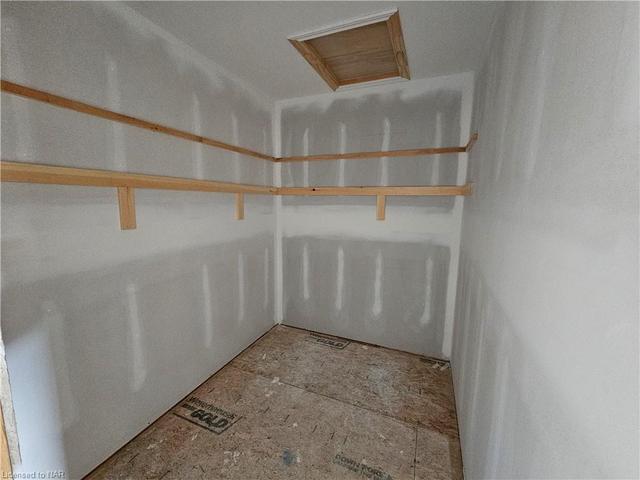 Large walk in closet w/ double shelves. | Image 10