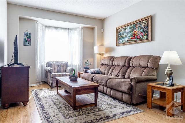 living room with hardwood flooring and bay windo | Image 3