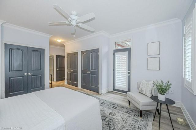 Large primary bedroom with 3 large closets and access door to deck and hot tub | Image 17