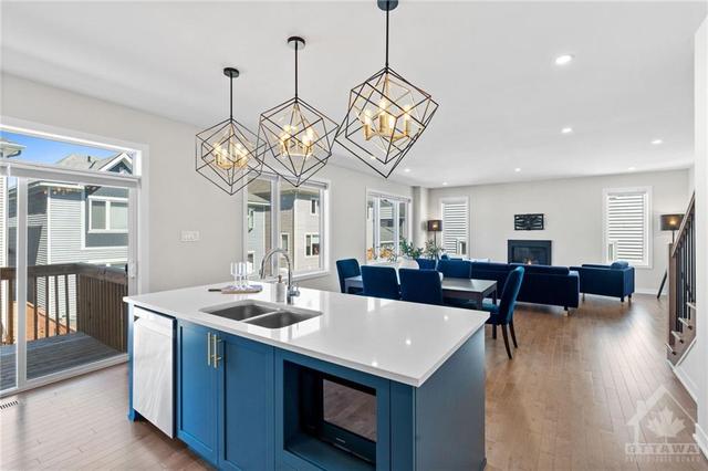 Quartz kitchen island has open concept view of dining & living space. Great for hosting and entertaining while cooking a fantastic meal. | Image 15