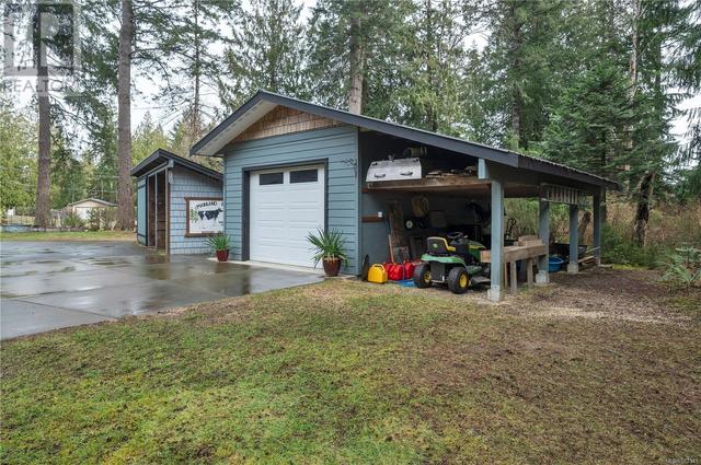the driveway is paved all the way to the 16'x24' detached shop with 10'x24' covered bay.  The shop has an automatic door & built-in work bench | Image 3