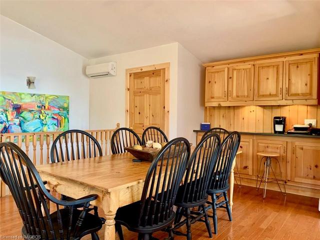 Dining area offers a 7ft Pine Harvest Table with 8 solid Maple Chairs & built-in Pine side buffet / counter area with undermount accent lighting. | Image 3