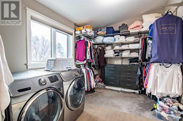 Primary closet with laundry | Image 9