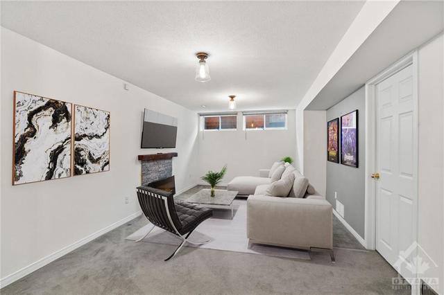 Basement- Rec room w/ electric fireplace, access to laundry room & expansive storage/utility room. | Image 26