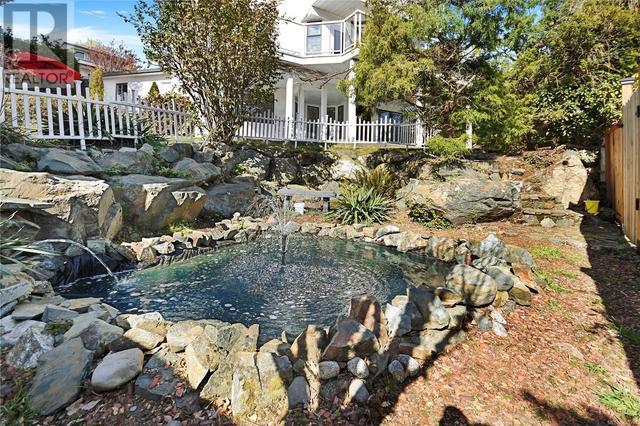 The property is nicely landscaped with private sitting areas throughout. This serene pond is a relaxing retreat | Image 40