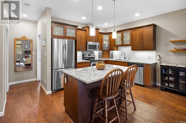 Granite countertops and gas connection located behind electric stove | Image 5