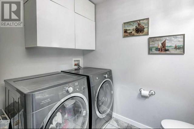 Main floor laundry room with storage space | Image 24