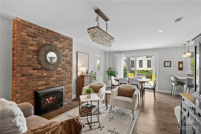 Casual second living space with original brick gas fireplace. | Image 13
