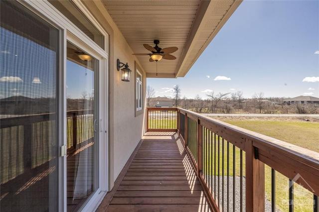 Off of your dining area is this large, covered deck with a fan for comfort in the warmer seasons. | Image 11