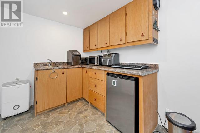 Suite kitchen with all of the small appliances you need to start cooking! 220 for a an electric stove if desired. Room for a fridge as well. | Image 17