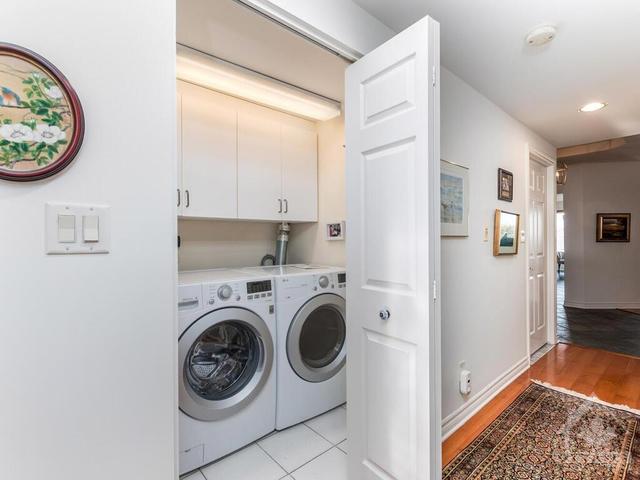 Separate laundry room with ceramic tile flooring and storage cabinets! | Image 21