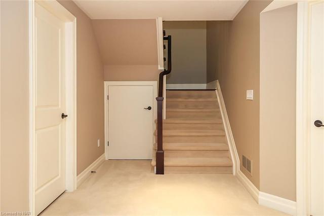 Conveniently located is the main bathroom and in the hall, a built-in armoire and storage closet. | Image 11