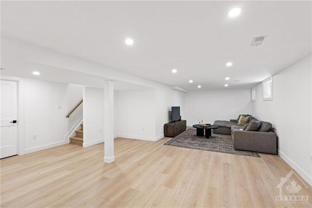 The lower level has an abundance of finished space waiting to be used. The floor is luxury vinyl plank. Potlights are on a dimmer. | Image 25