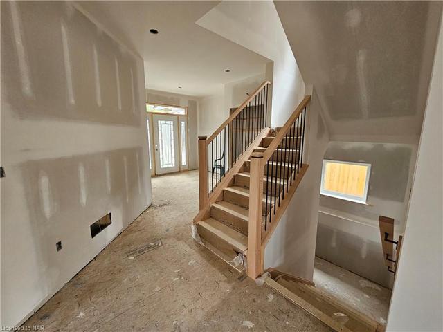 Oak stairwell to upper and partly finished lower level w/ iron spindles. | Image 2