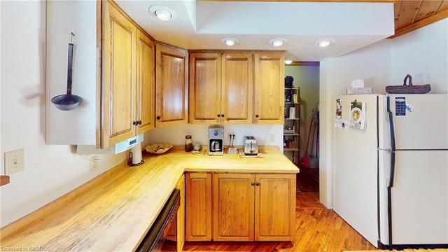 Kitchen equipped with stove top, oven, microwave, dishwasher, and refrigerator | Image 6