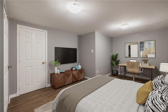 An additional view of the 4th bedroom in the lower level. This room adds more versatility to work with for whatever your family needs. (virtually staged photo). | Image 26