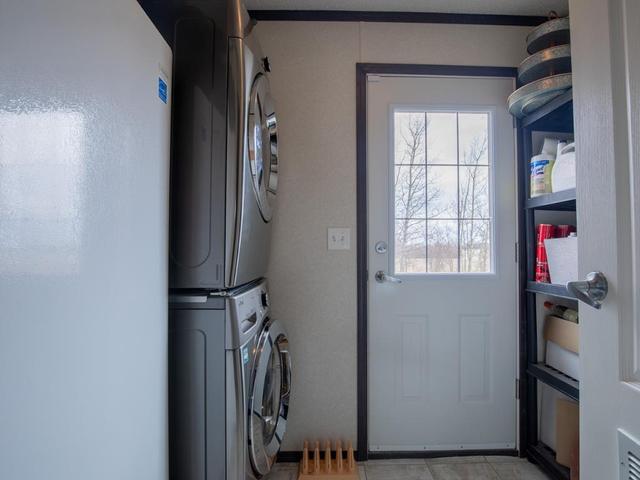 Large utility and laundry room featuring new, stackable washer & dryer | Image 31