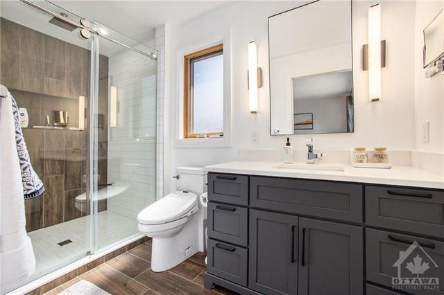 Newly renovated primary ensuite features heated floors, smart toilet and large shower with built-in niche | Image 17