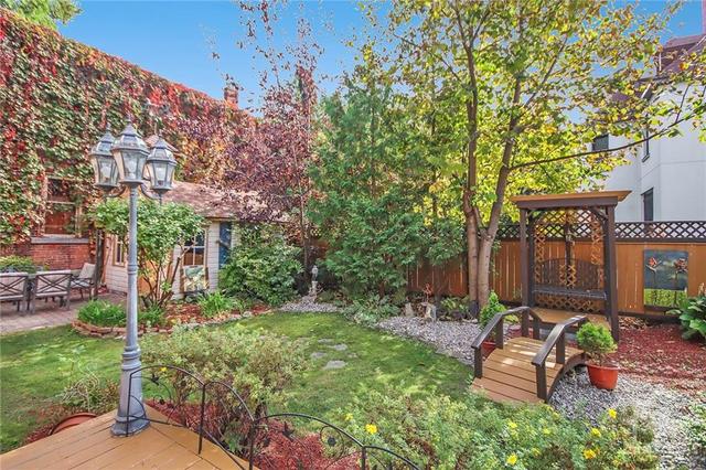 View of the private, quiet garden area and large doll house storage shed. Life sure is good when it is peaceful and tranquil. | Image 28