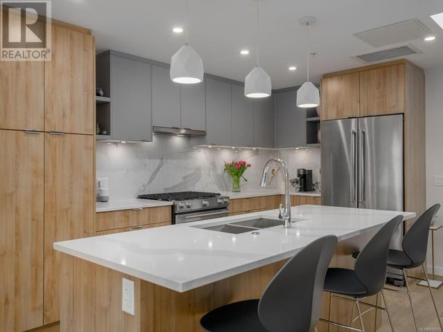 Kitchen with KitchenAid appliances and quartz countertops. | Image 1