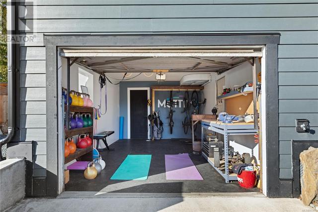 Garage set up as gym & work area w/storage | Image 27