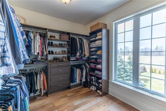 Oversized custom walk-in closet with beautiful views of the backyard and pool deck. | Image 26