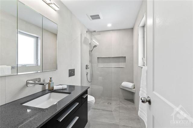 Primary 3 piece ensuite w/ curb-less shower, floating vanity, heated floors, and wall hung toilet. | Image 19