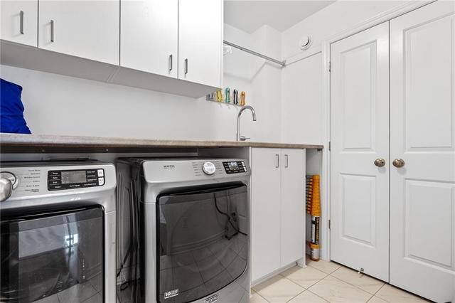 Second floor laundry with uppers, sink, countertop and large linen closet | Image 23