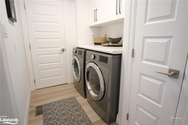 Main floor laundry with additional storage | Image 25