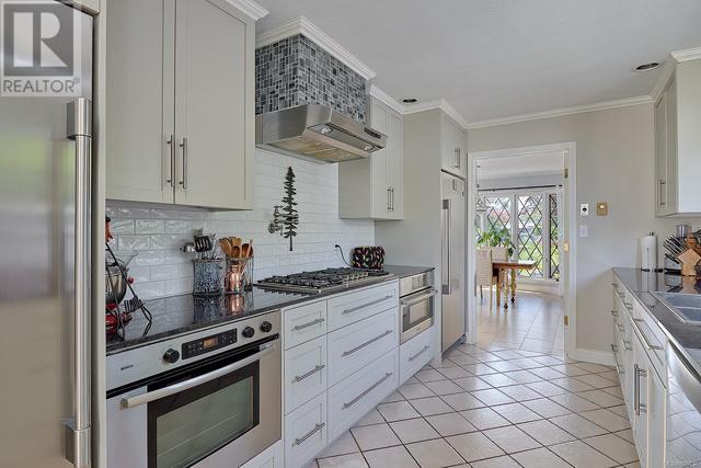Completely renovated Efficient galley kitchen. New chefs delight appliances: gas cooktop,b/in electric range, b/in microwave, hood fan, pot filler,full size freezer & fridge, wine fridge,granite CT | Image 2