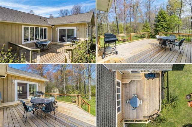 Various angles of the deck with updated spindled railing & corner staircase, all overlooking your extremely private backyard. | Image 20