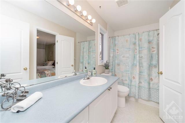 Lovely and bright cheater 4-piece ensuite bathroom for the two spare bedrooms on the upper level. | Image 20