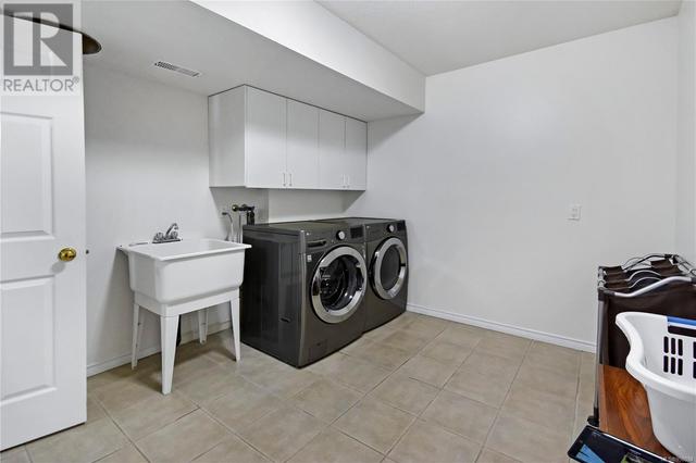 The laundry room is huge with access from the suite and the home | Image 65